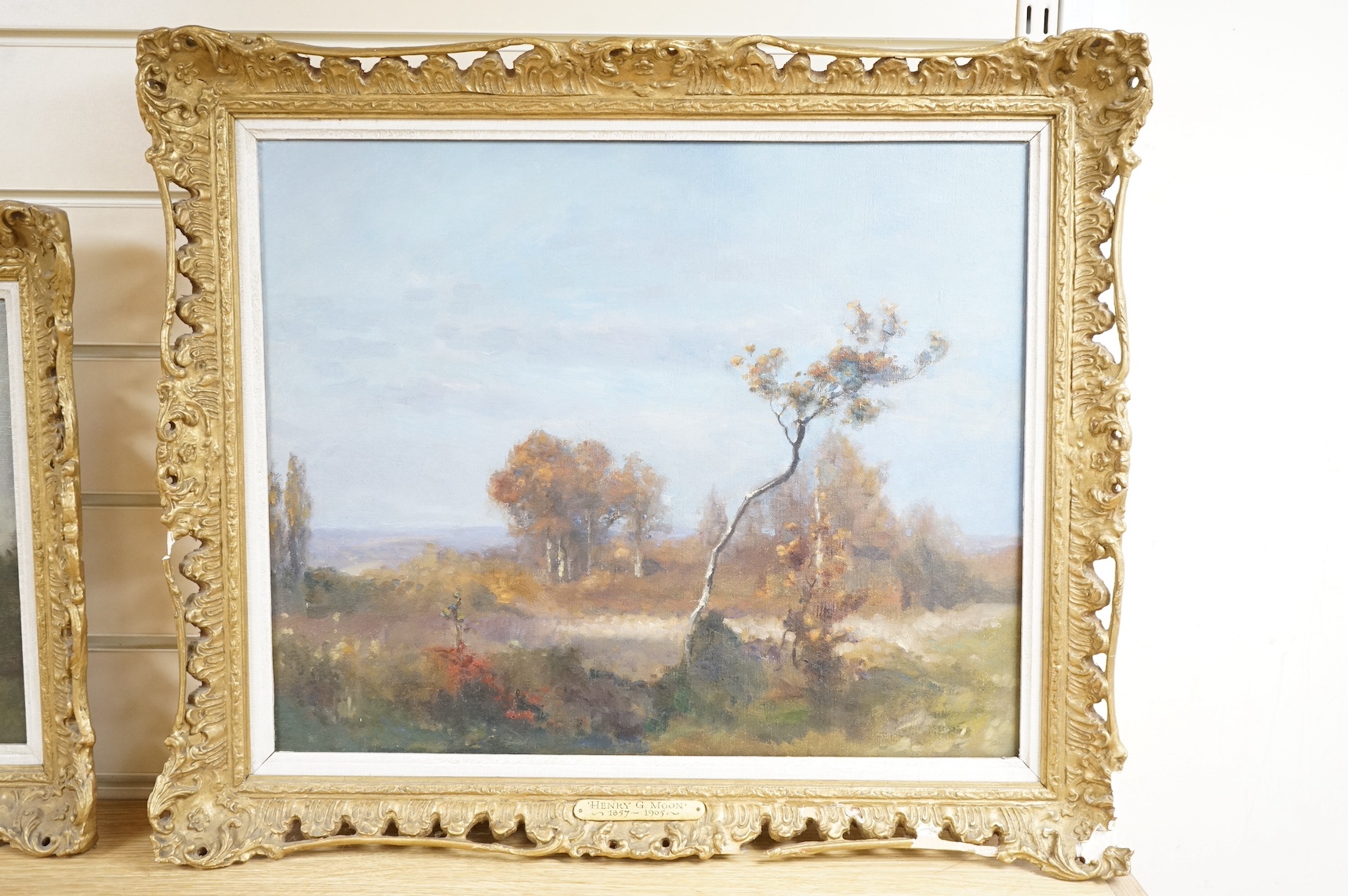 Henry G. Moon (1857-1905), oil on canvas, Autumnal landscape, signed in ink verso, 39 x 48cm, applied plaque to the ornate gilt frame. Condition - good, losses to the frame